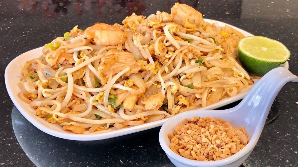 Chicken & Shrimp Pad Thai · Spicy. Stir-fry rice noodles tossed in tangy sauce, topped with peanuts.