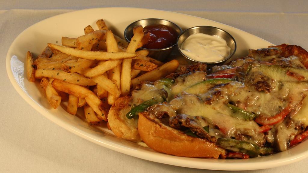 Philly Cheese Steak · Shaved prime rib, melted white cheddar cheese, sautéed mushrooms, onions, and peppers on a fresh hoagie.