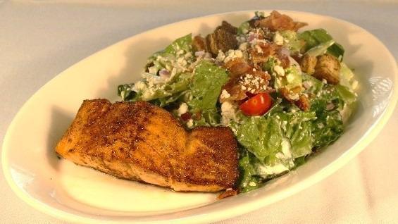 Black & Blue Salmon Salad · Blackened salmon, mixed greens tossed with blue cheese dressing, grape tomatoes, bacon, red onion, marble rye croutons, and more blue cheese crumbles.