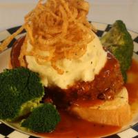 Cap City Diner Meatloaf · Buttermilk-chive mashed potatoes, wild mushrooms, broccoli, chili onion rings, and BBQ gravy...