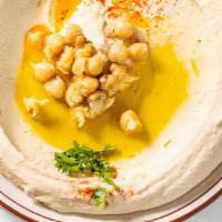 Half Hummus · Pureed chickpeas, creamy tahini sauce, garlic, served with warm pita bread.