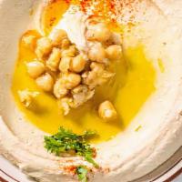 Whole Hummus · Pureed chickpeas, creamy tahini sauce, garlic, served with warm pita bread.