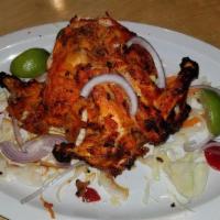 Tandoori Cornish Hen - Two · Whole Hen marinated with yogurt, spices and cooked in clay oven.