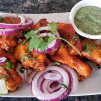 Tandoori Chicken - Half (4 Pieces) · Chicken marinated with yogurt, spices and cooked in clay oven.