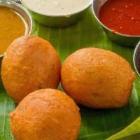 Mysore Bonda (4 Pcs) · Mysore bondas are fried dumplings made with flour, yogurt and spices. They are crispy outsid...