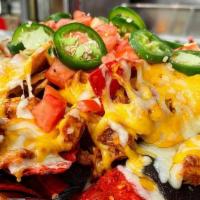 Mustang Nachos · Pulled chicken mixed with Honey BBQ sauce served over tri-colored tortilla chips and topped ...