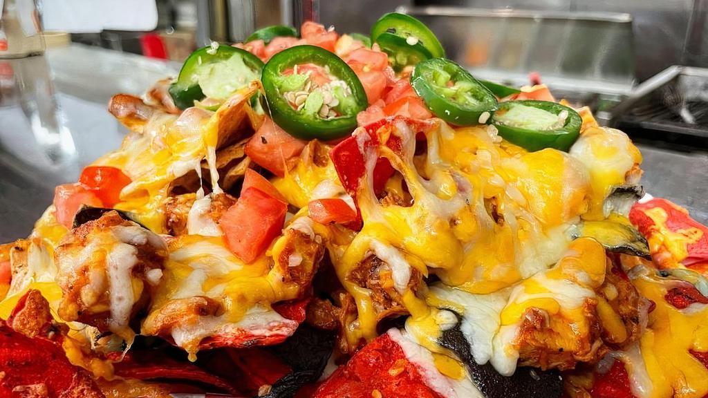 Mustang Nachos · Pulled chicken mixed with Honey BBQ sauce served over tri-colored tortilla chips and topped with shredded Colby Jack Cheese, diced tomatoes and fresh jalapenos. Served with Red Pepper Dip