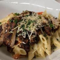 Cajun Chicken Pasta · Homemade Alfredo Sauce tossed with Penne Noodles and Red Peppers topped with grilled Cajun C...