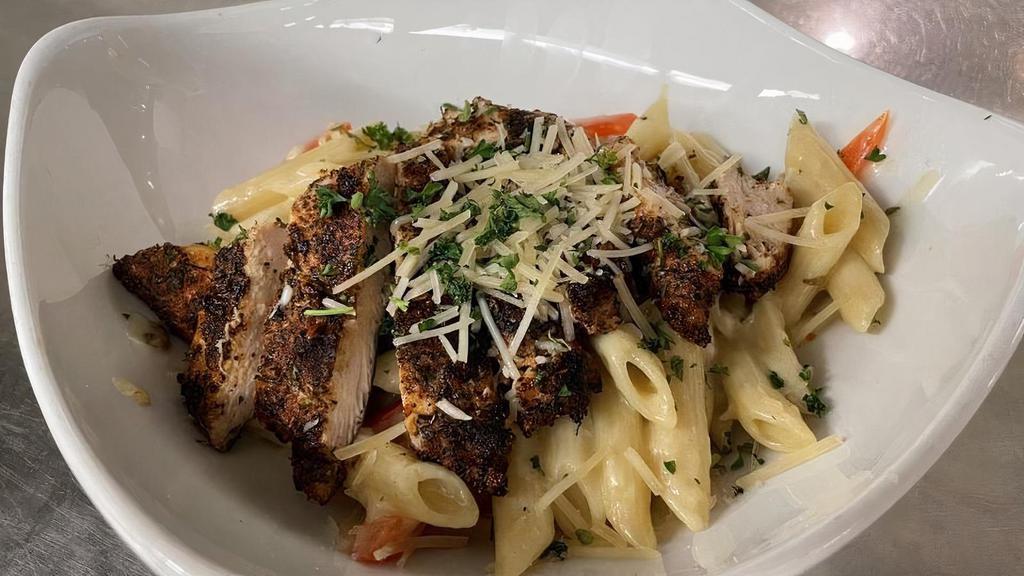 Cajun Chicken Pasta · Homemade Alfredo Sauce tossed with Penne Noodles and Red Peppers topped with grilled Cajun Chicken Breast.