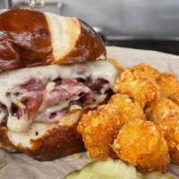 Pastrami Stacker · Thinly sliced Pastrami and melted Swiss Cheese stacked high on a toasted Pretzel bun with pi...