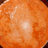 Traditional Tomato Soup · Traditional Tomato Soup topped with Parmesan.