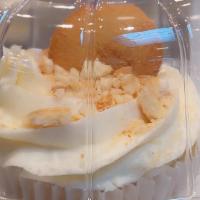 Banana Pudding · Our gourmet vanilla cupcake with banana pudding center topped with vanilla wafers.