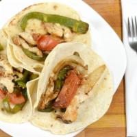 Fajitas · Tender strips of marinated chicken breast or sirloin steak with sautéed onions, bell peppers...