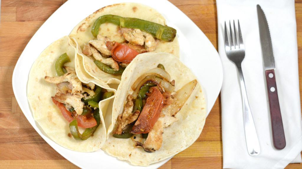 Fajitas · Tender strips of marinated chicken breast or sirloin steak with sautéed onions, bell peppers and tomatoes.