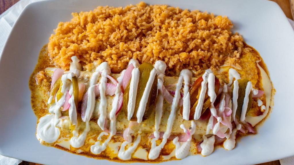 Burrito Cochinita · A flour tortilla filled with cochinita pibil (Mexican slow-roasted pork marinated in citrus juice and annatto) covered in our special meat and cheese sauce. Drizzled with sour cream, served with rice.