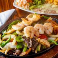 Fajitas Amigos · Marinated strips of sirloin steak, chicken and shrimp with sautéed onions, bell peppers and ...