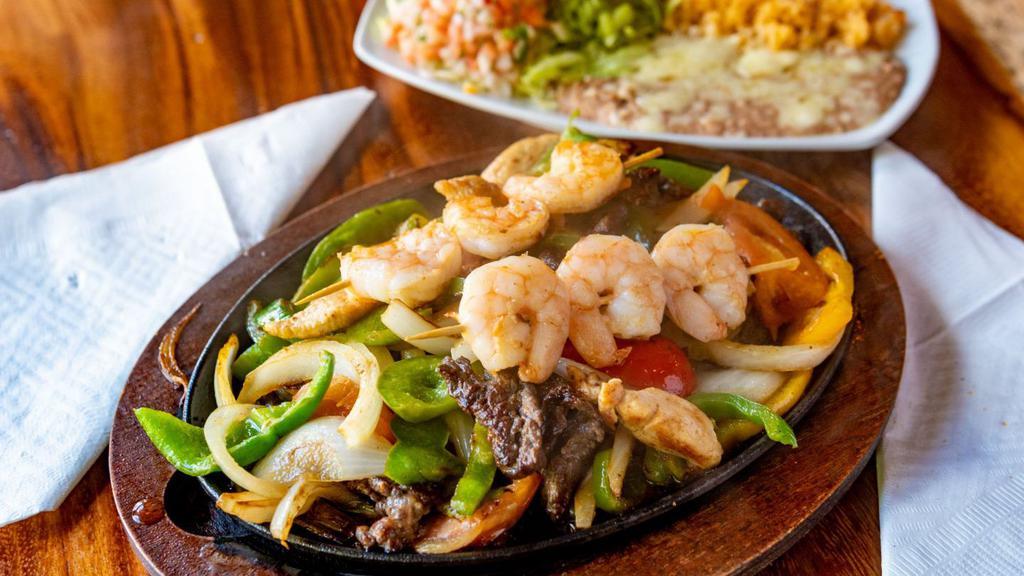 Fajitas Amigos · Marinated strips of sirloin steak, chicken and shrimp with sautéed onions, bell peppers and tomatoes.
