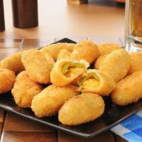 Cheddar Poppers · Jalapeños stuffed with cheddar cheese, battered and fried until crispy and golden.
