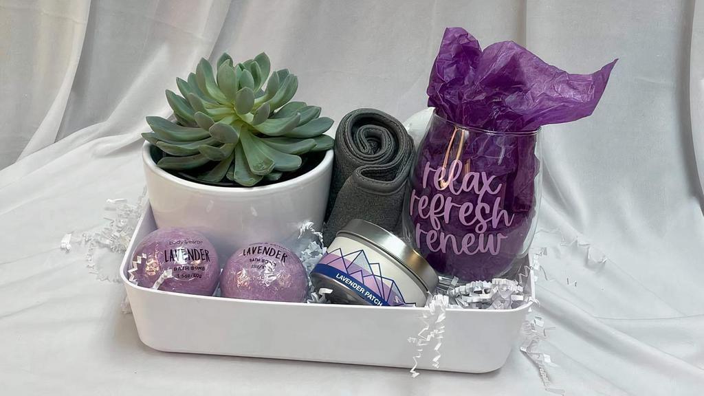 Spa Day Gift Basket · Relax, Refresh, Renew! Send this gift basket for that extra special Self Care Day! The gift basket includes a succulent plant, a lavender scented candle, lavender bath bombs, a cloth spa headband and a wine glass. *Substitutions will be made to value if necessary* Please include the recipients name and a card message in the special instructions.