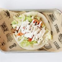 Tacos American · Choice of meat, topped with lettuce, cheese, tomato & sour cream on a flour tortilla. Add tr...