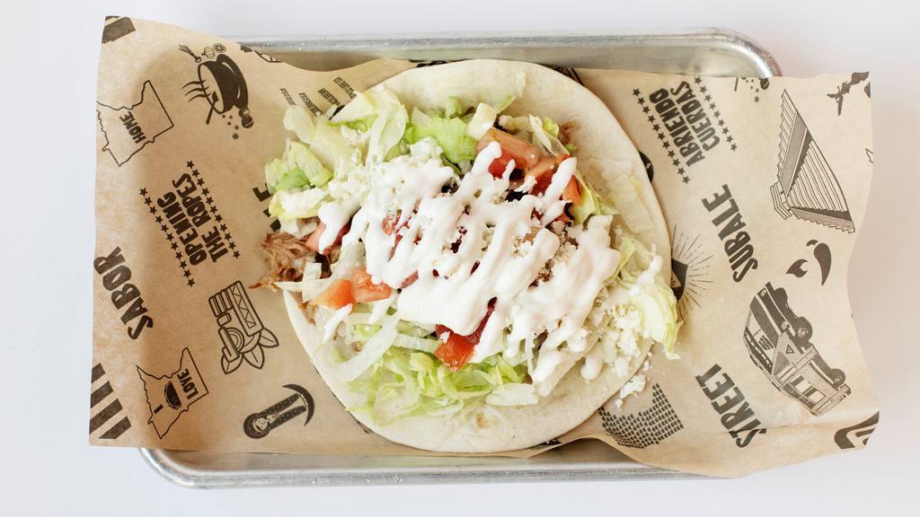 Kids' American Taco · Flour tortilla, lettuce, cheese, tomato, sour cream & choice of meat.