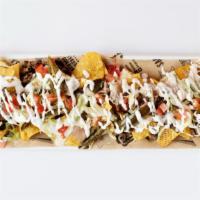 Nachos · Choice of meat, refried beans, queso dip, lettuce, tomato, jalapeños & sour cream. Add tripe...