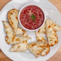 Garlic Cheese Bread · Served with red sauce.