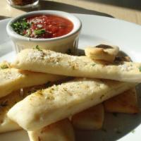 Breadsticks · Served with red sauce.