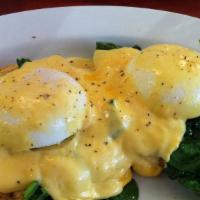 Eggs Benedict Florentine · An English muffin with poached eggs, old fashioned smoked ham, spinach and hollandaise sauce...