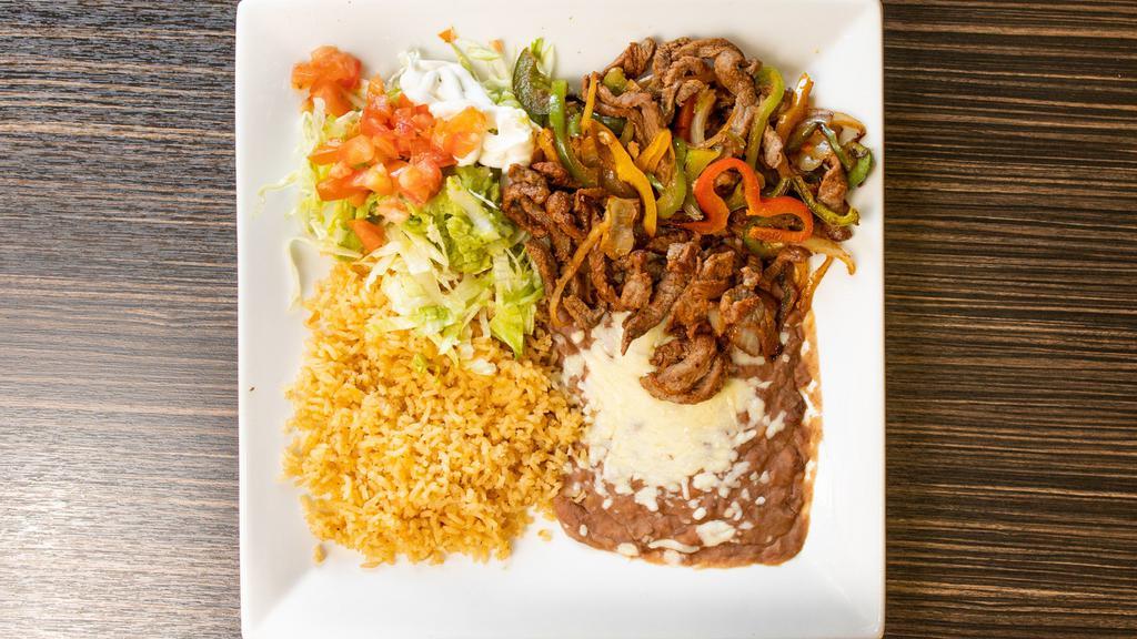 Pork Fajitas · Served with rice, beans, lettuce, guacamole, tomatoes, sour cream, rice and refried or black beans.