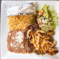 Carne Asada · A mouthwatering thinly slice steak grilled and topped with green onions, served with beans, ...
