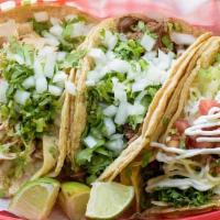 Taco · Corn or flour tortilla, with choice of meat, topped with onions, and cilantro. Served with h...