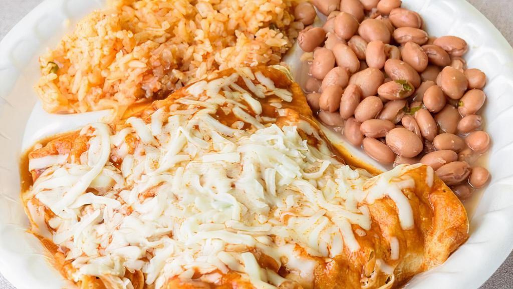 Meat Enchiladas · Rolled corn tortillas, filled with  choice of meat, covered with enchilada sauce, topped  with cheese served with a side of rice and beans.