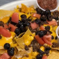 Macho Nachos · Ground beef or chicken, tomatoes, cheese, onions, black olives, jalapenos, sour cream, and s...