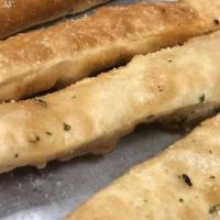 Homemade Breadsticks · Deep fried pizza dough with butter and Parmesan cheese.