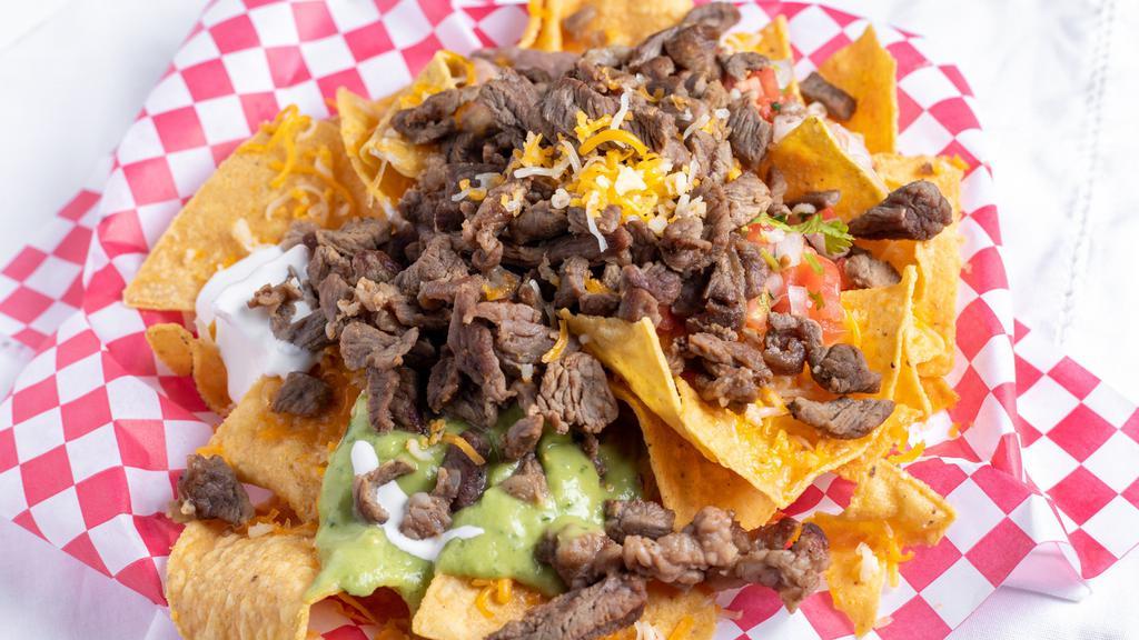 Half Super Nachos · Fried corn chips covered with shredded cheese and your choice of meat. Toppings include guacamole, pico de gallo, refried beans, and sour cream.