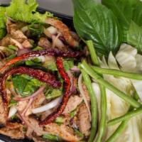 Grilled Pork Salad (Moo Nam Tok) · Sliced grilled pork, ground roasted rice, red onion, green onion, mint, cilantro mixed in sp...