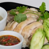 Thai Chicken Rice (Kao Mun Gai) · Poached chicken over ginger rice, served with cucumbers, homemade soybean sauce and a side o...