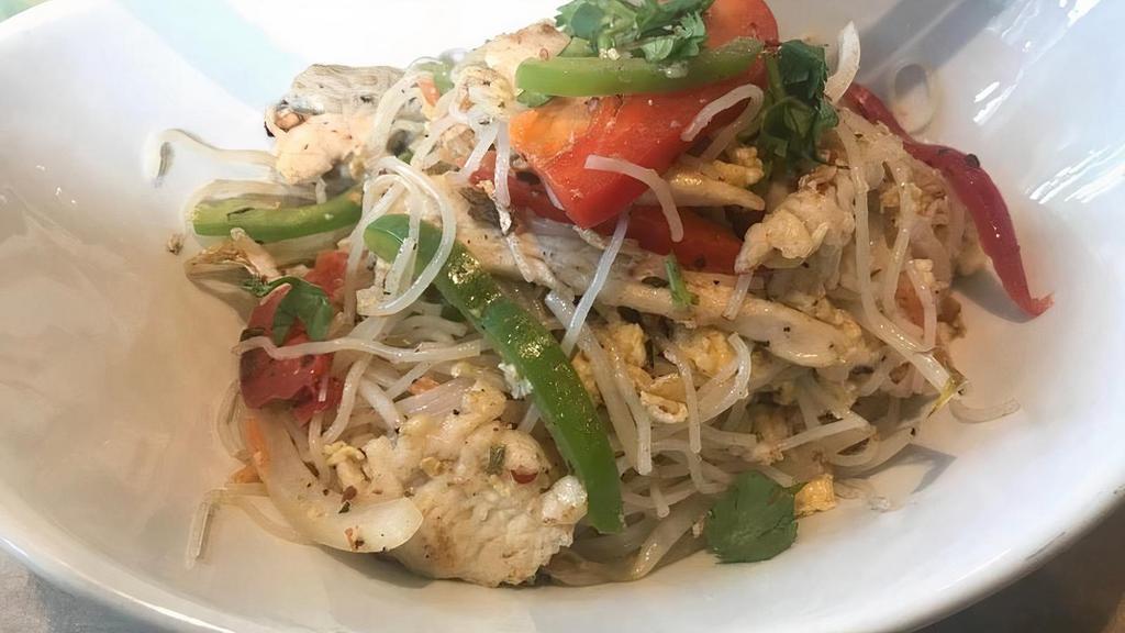 Singapore Chicken Noodle · Chicken wok-tossed with eggs, scallions, yellow onion, bean sprouts, green and red peppers, with a house-blended curry mix, chili flakes, and vermicelli noodles