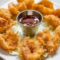 Coconut Shrimp · 10 tail on shrimp fried in a spiced coconut and panko breading. Served with sweet chili sauce.