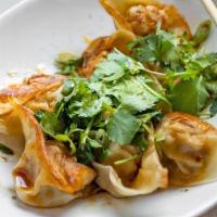 Pan Fried Pork Wontons With Hot Chili Sauce · 8 rich and tangy pork wontons pan fried golden brown and served in a spicy chili sauce (Not ...