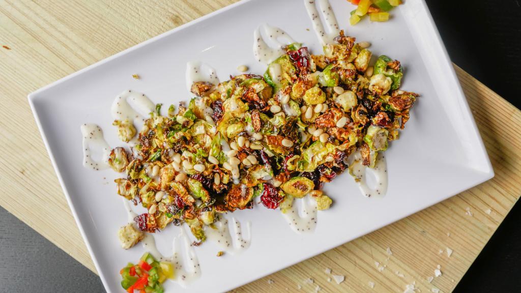 Crispy Brussel Sprouts · Grilled to perfection, topped with pine nuts, cranberries, and sweet and tangy poppy seed dressing.