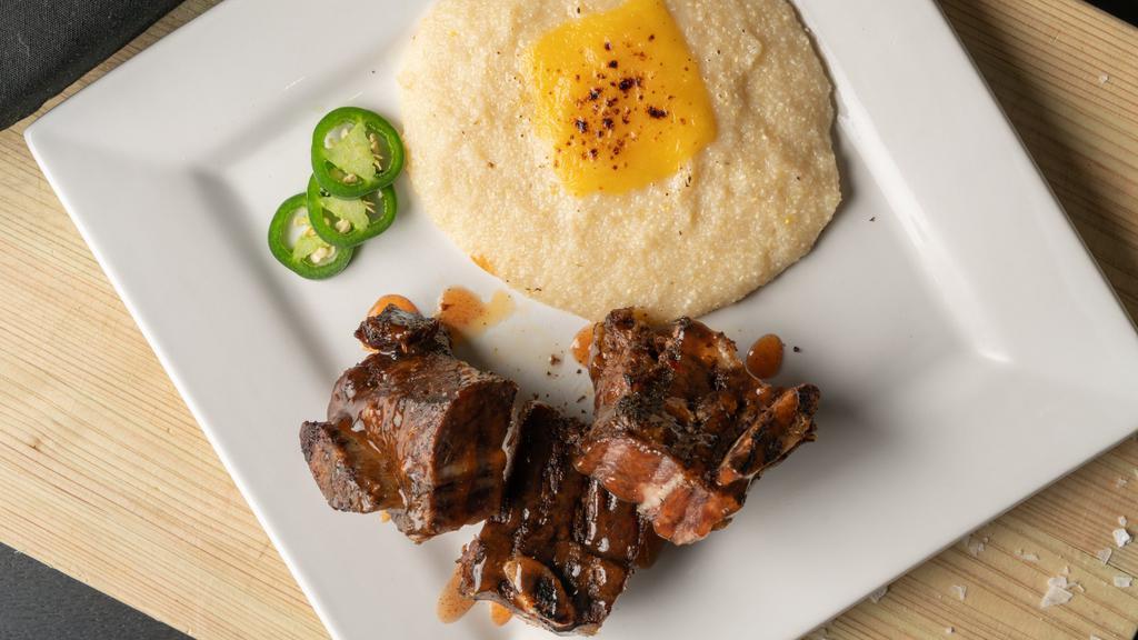 Beef Short Ribs · Smoked beef short ribs served with gouda grits.
