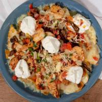 Nachos Al Carbon · A bed of chips with melted cheese, topped with grilled steak, chicken, shrimp, pico de gallo...