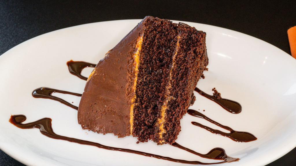 Galaxy Cake · Dark chocolate cake with caramel sauce under chocolate cream cheese mousse with chocolate cookie crumb.