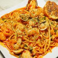 Pasta Brava · Shrimp, Mussels, Clams, Mushrooms, Bell Pepper in a creamy red spicy sauce.