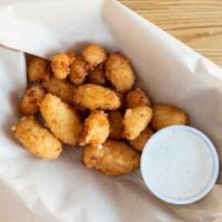 Wisconsin Cheese Curds · Vegetarian. White cheddar cheese curds lightly dusted and fried golden brown. Served with ho...