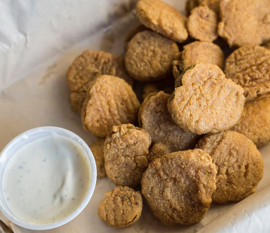 Fried Pickle Chips · A healthy portion of breaded dill pickle slices, crispy fried and served with a side of homemade ranch. You won't want to share them.