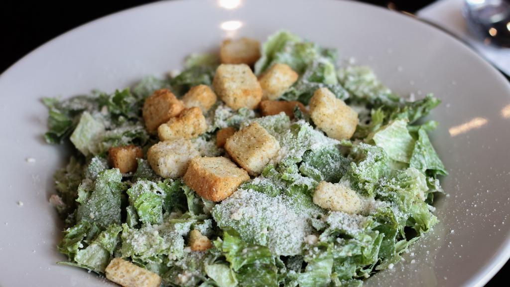 Caesar Salad · Chopped romaine lettuce tossed with parmesan cheese, croutons and homemade Caesar dressing.