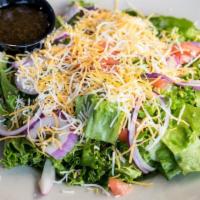 House Salad · Crisp greens topped with tomato, onion, shredded cheese and croutons.